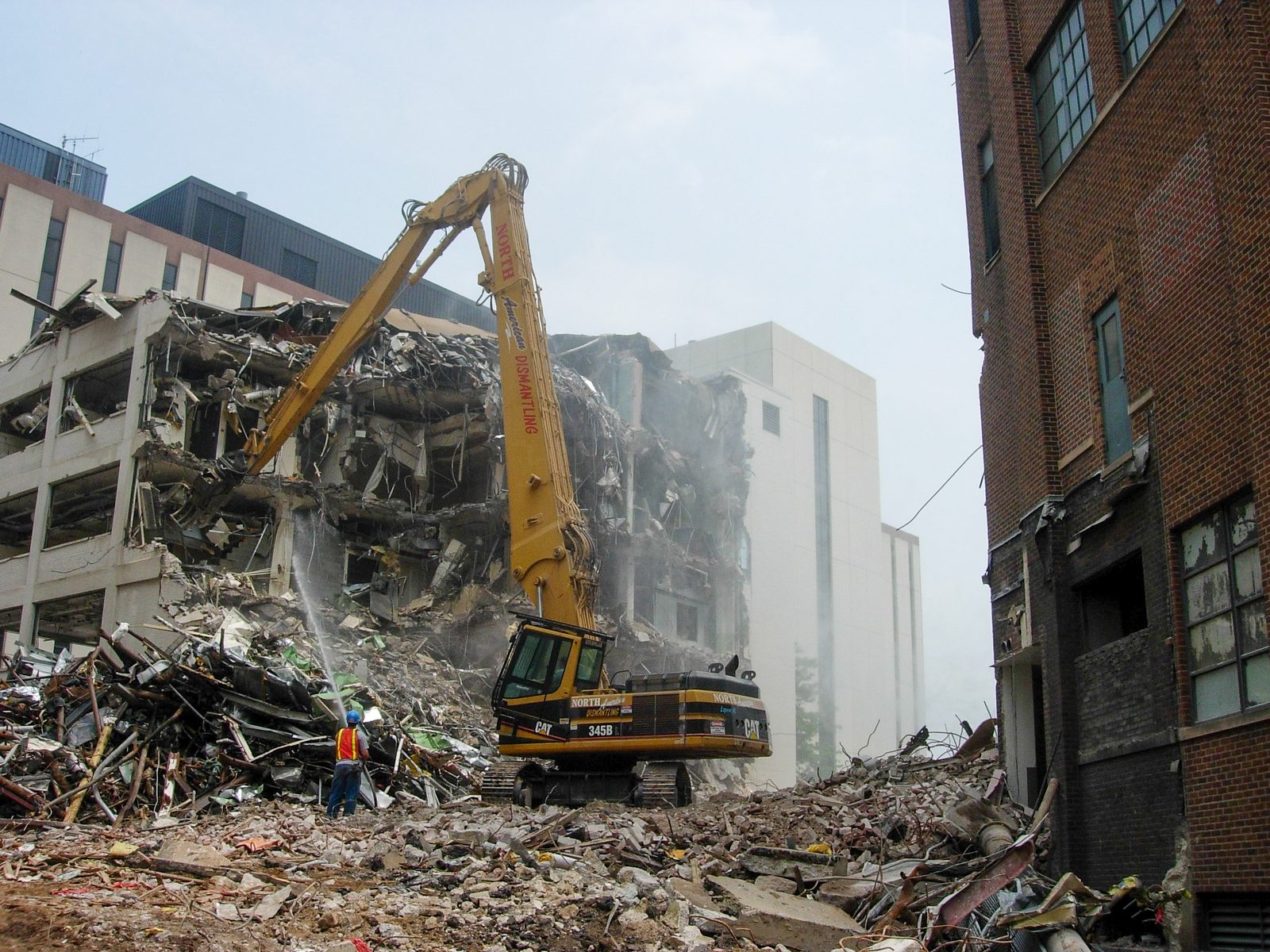 NADC high-reach excavator removing a multi-story building at the Kalamazoo pharmaceutical campus