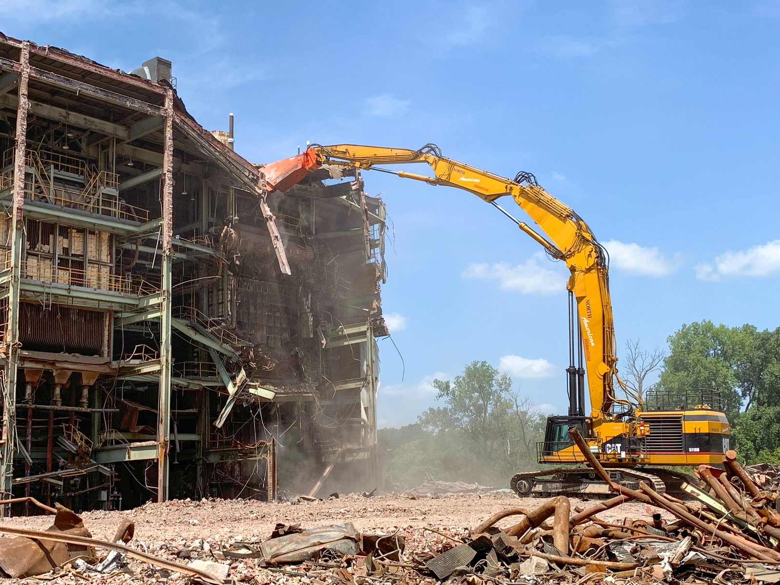 NADC high-reach excavator pulling down the boiler house of a retired power station